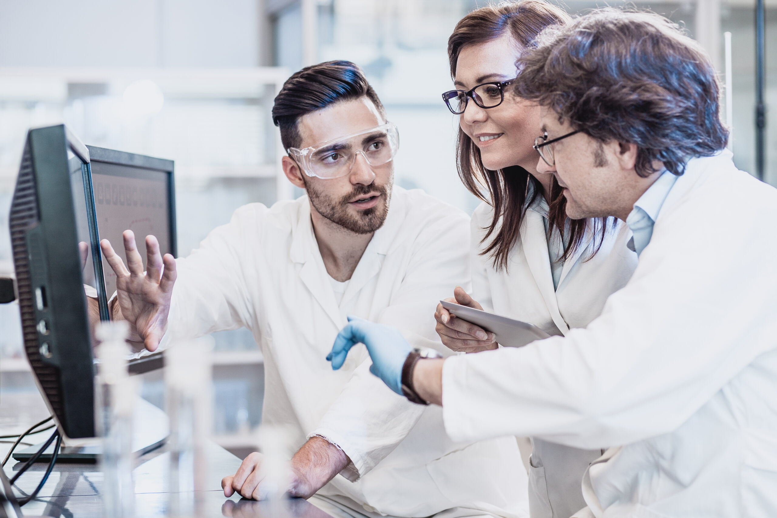 Scientists discussing in the laboratory, using computer